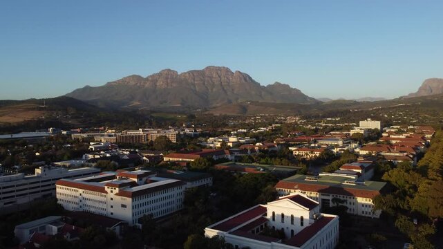 Evening aerial drone panorama above Stellenbosch, south Africa with a view towards the Simonsberg and hottentots mountain. Beautiful evening view