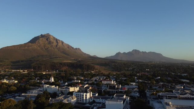 Evening aerial drone panorama above Stellenbosch, south Africa with a view towards the Simonsberg and hottentots mountain. Beautiful evening view