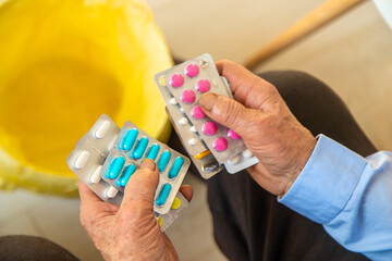 Old woman with medicine. Selective focus.