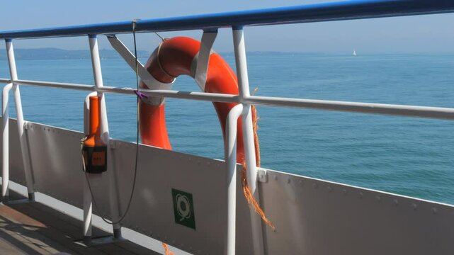 Scenic View from a Ferry with a Lifebuoy Overlooking the Calm Sea