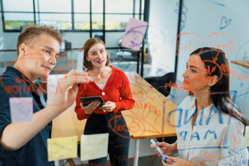 Creative business team brainstorming discussing and sharing marketing idea about start up project by using mind map colorful sticky note at glass board meeting room. Working together. Immaculate.
