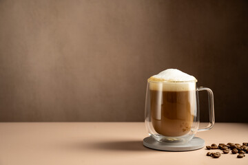 Coffee latte glass cup mug with milk foam and instant coffee, copy space