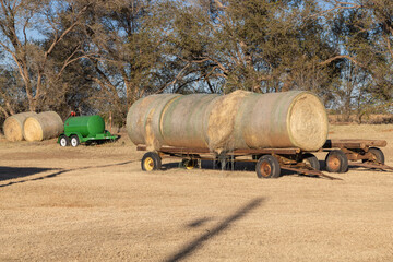 Round hay bales on a trailer.
