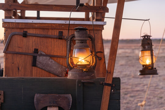 Kerosene lanterns hanging on an old chuck wagon.
