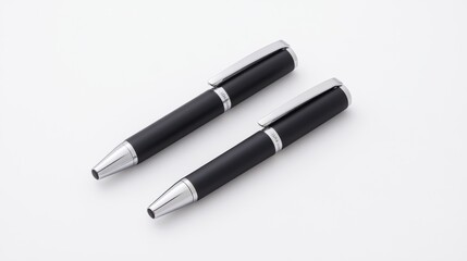 Elegant Black Pens with Silver Accents on a Clean White Surface for Office or Personal Use