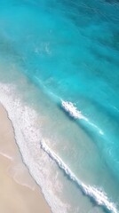 aerial view of a turquoise ocean with gentle waves, mobile phone wallpaper, background