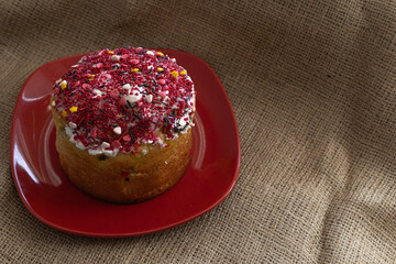 Easter cake with icing on a red plate
