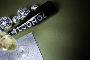 Glasses with champagne and a bottle with the inscription "Alcohol"