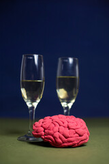 Glasses with champagne and a decorative plasticine brain