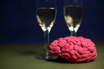 Glasses with champagne and a decorative plasticine brain