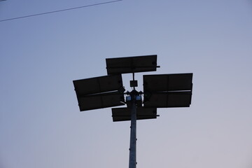 Solar-powered street light or floodlight system, identifiable by the multiple solar panels attached to the pole