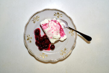 cottage cheese with cherries and tea lie on the kitchen table