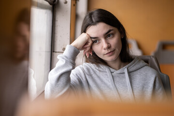 Thoughtful Young Caucasian Woman Looking Through Train Window Wearing Casual Sweatshirt. Lisbon,...