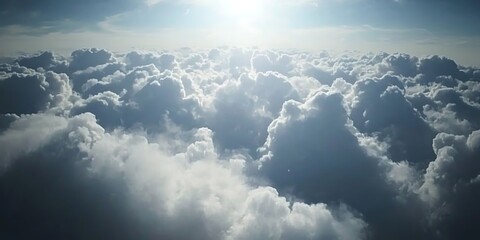Over the cloudscape of a bright sky with dense cumulus formations