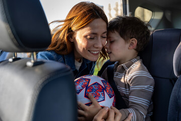 Mom and son enjoying a happy moment in the car before playing soccer © Budimir Jevtic