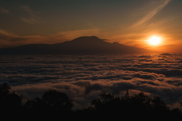 Sun rising over kilimanjaro, tanzania, africa, creating a sea of clouds at dawn