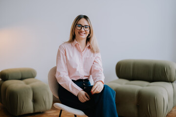 Obraz premium Business woman employee. Professional female on a chair in a cozy office space.
