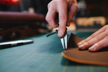 Banner tailor industry craftsman. Leather rolls and tools for handmade craft in workshop