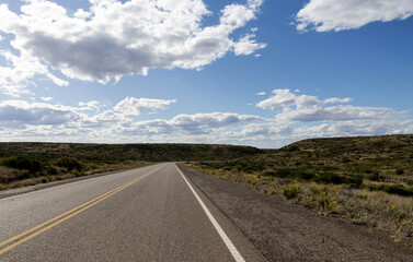 A section of national route 3 in Argentine Patagonia surrounded by lush green hills