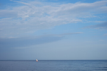 Sailboat in the distance in good weather on the lake.