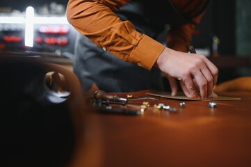 Banner tailor industry craftsman. Leather rolls and tools for handmade craft in workshop