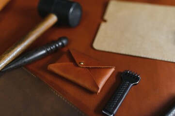 Crafting tools on natural cow leather in the tailoring workshop. Top view
