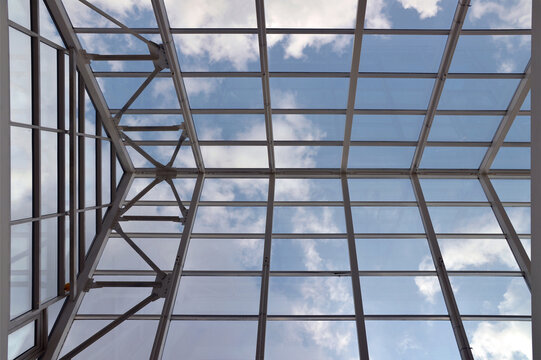 Modern glass roof and blue sky - Powered by Adobe