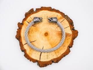 Silver wolf head bracelet with a rustic wooden base. Fashion design for men and women. Bracelet of strength, fighting spirit, and wisdom. Nordic urban life.