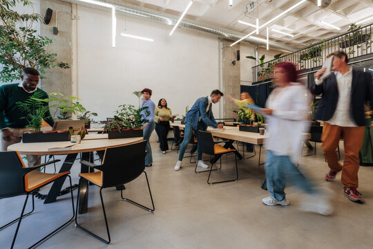 Busy international team working in modern green office