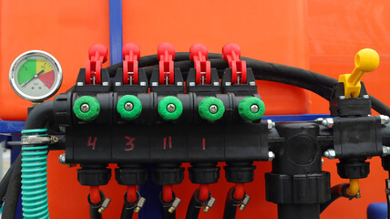Mixer mechanism for agricultural pest sprayer with color-coded valves and pressure gauge