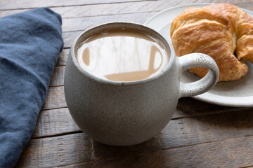 Morning Coffee and Fresh Croissant on Wooden Table