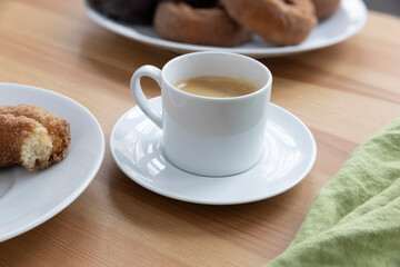 Close Up of White Mug of Espresso on wooden table.