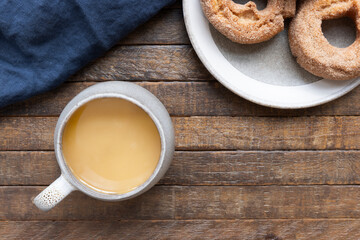 Coffee and Donuts on Rustic Wooden Table.