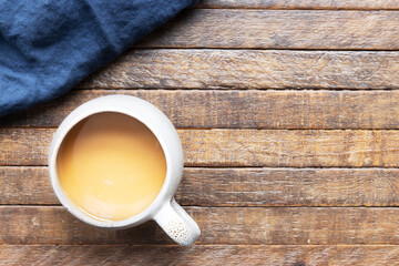 Flat Lay of Coffee Cup on Rustic Wooden Table with Copy Space