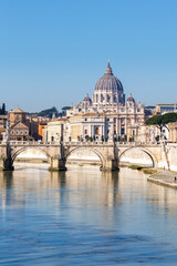 Rome skyline with St. Peter's Basilica in Vatican Ponte Sant'Angelo bridge over Tiber river...