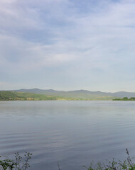 Calm lake with mountains in the background