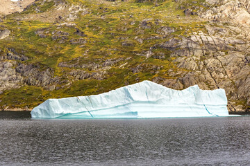 Atlantic Ocean, Greenland - 28 August 2024: Scenic landscape view of an iceberg in a fjord in...