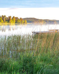 Dock is on the water next to a lake