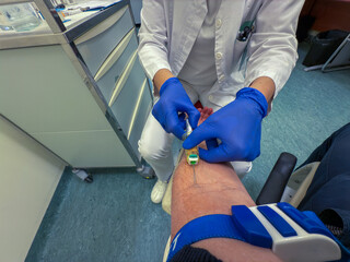 Doctor taking blood sample from a patient