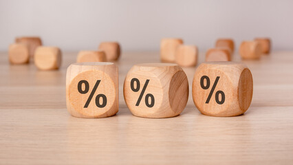 Wooden cubes with percentage symbols, representing finance, discounts, interest rates, and sales