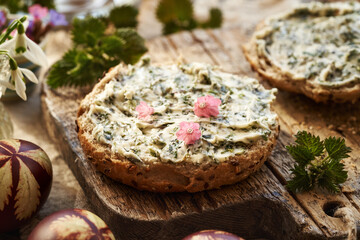A slice of bread with nettle butter and lungwort flowers collected in early spring