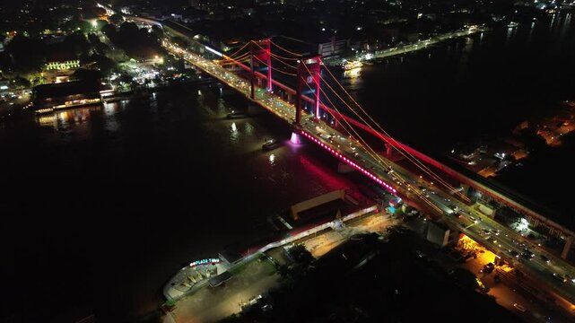 Aerial shot of Ampera Bridge at night, one of the landmarks of Palembang city, South Sumatra, Indonesia