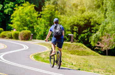 Cyclist ride on the bike path in the city Park
