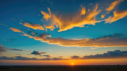 Obraz premium The morning sky appeared as a bright golden expanse. The sunrise is adorned with clouds of different shapes. It looks stunning.