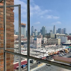 Downtown Los Angeles seen through a window in the Fashion District, with parking lots in the...