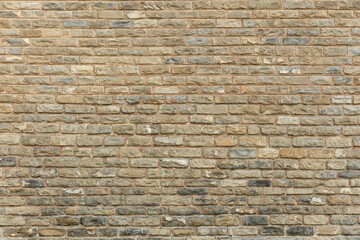 Textured surface of a rustic stone brick wall