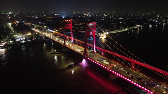 Aerial shot of Ampera Bridge at night, one of the landmarks of Palembang city, South Sumatra, Indonesia