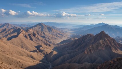 Fototapeta premium The mountains are brown and rocky, set against a clear blue sky. The scene is breathtaking and tranquil, with the mountains extending as far as one can see.