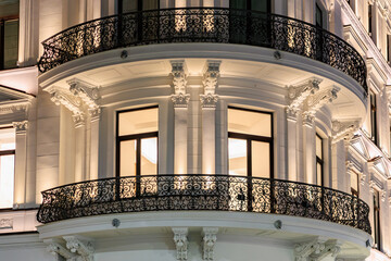 Elegant night view of historic european building facade with ornate balconies