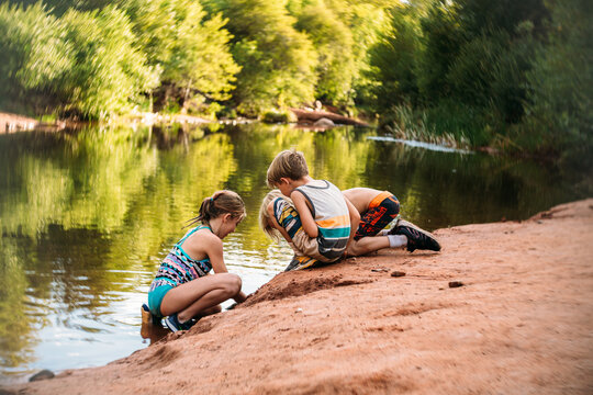 Kids playing on side of lake